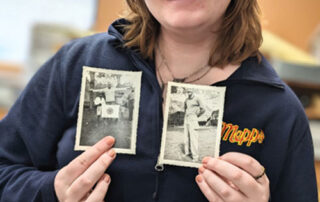 woman holding historical photos